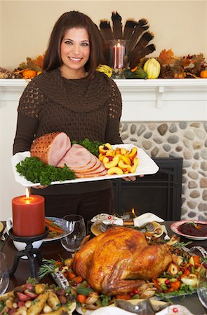 fine dining table setting with glasses - Woman Serving Thanksgiving Dinner Stock Photo - Premium Royalty-Free, Code: 600-01742528