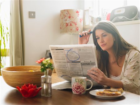 paper cup on table - Portrait of Woman Looking Through Newspaper Classifieds Stock Photo - Premium Royalty-Free, Code: 600-01742736