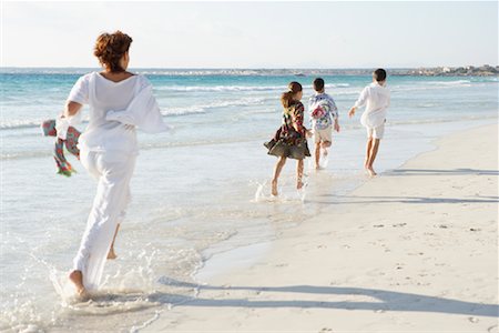 daughter and senior from behind - Family Running on the Beach Stock Photo - Premium Royalty-Free, Code: 600-01755489