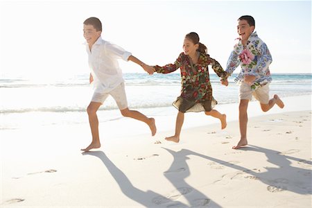 sister and brother running on beach in summer - Children Running on the Beach Stock Photo - Premium Royalty-Free, Code: 600-01755493