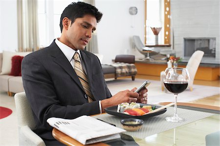 eyes lowered - Man Using Cellular Phone at Dinner Table Stock Photo - Premium Royalty-Free, Code: 600-01753560