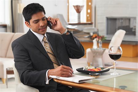 Man Using Cellular Phone at Dinner Table Stock Photo - Premium Royalty-Free, Code: 600-01753563