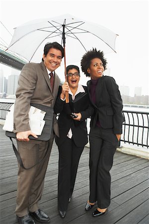 sharing umbrella - Business People Under Umbrella by East River, New York City, New York, USA Stock Photo - Premium Royalty-Free, Code: 600-01764134