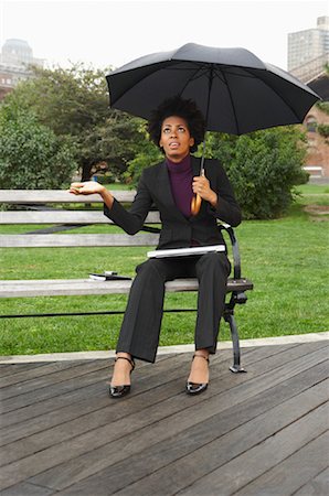 Businesswoman on Park Bench in Rain, New York City, New York, USA Stock Photo - Premium Royalty-Free, Code: 600-01764132