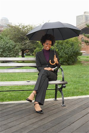 Businesswoman on Park Bench in Rain, New York City, New York, USA Stock Photo - Premium Royalty-Free, Code: 600-01764133