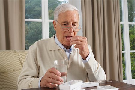 Man Taking Medication Stock Photo - Premium Royalty-Free, Code: 600-01764470