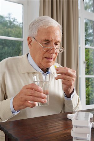 Man Taking Medication Stock Photo - Premium Royalty-Free, Code: 600-01764471