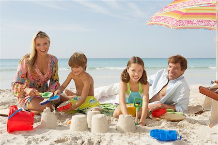 portrait of family lying down side by side - Family Playing in Sand on Beach, Majorca, Spain Stock Photo - Premium Royalty-Free, Code: 600-01764735