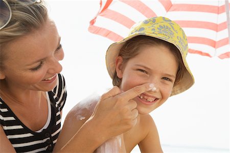 sun umbrella - Mother Applying Sunscreen to Boy's Nose, Majorca, Spain Stock Photo - Premium Royalty-Free, Code: 600-01764741