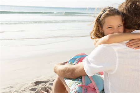 Girl Hugging Father on Beach, Majorca, Spain Stock Photo - Premium Royalty-Free, Code: 600-01764760