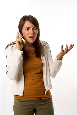 Annoyed Woman Talking on Cell Phone Stock Photo - Premium Royalty-Free, Code: 600-01765029