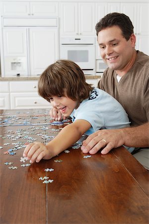 family playing in the kitchen - Father and Son Doing a Jigsaw Puzzle Stock Photo - Premium Royalty-Free, Code: 600-01787591