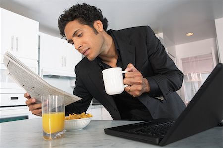 Businessman at Home, Reading Newspaper Stock Photo - Premium Royalty-Free, Code: 600-01787674