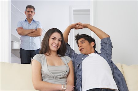 Portrait of Couple, Angry Man in Background Stock Photo - Premium Royalty-Free, Code: 600-01787694