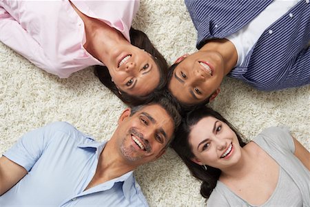 family lying on carpet - Portrait of Family Lying in a Circle Stock Photo - Premium Royalty-Free, Code: 600-01787707