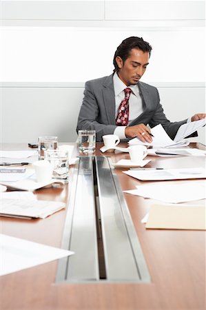 simsearch:600-02332687,k - Businessman at Boardroom Table with Cellular Phone and Documents Stock Photo - Premium Royalty-Free, Code: 600-01788810