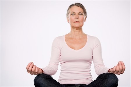 senior woman meditating - Mature Woman Meditating Stock Photo - Premium Royalty-Free, Code: 600-01792457