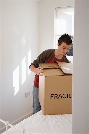 Boy with Cardboard Box in Room Stock Photo - Premium Royalty-Free, Code: 600-01827156