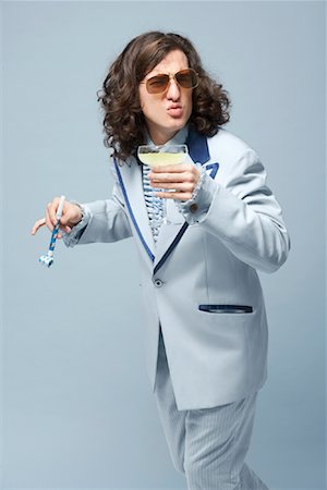 funny cocktail images - Man With Beverage and Noisemaker Stock Photo - Premium Royalty-Free, Code: 600-01837494