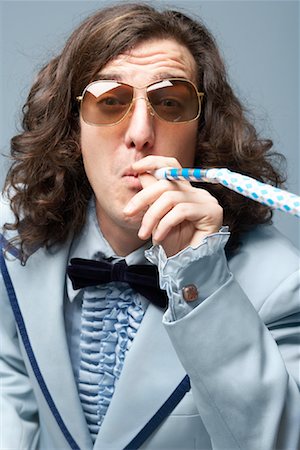retro funny fashion pictures - Man Blowing Noisemaker Stock Photo - Premium Royalty-Free, Code: 600-01837492