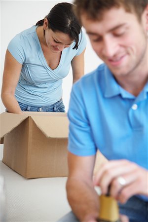 Couple in New Home with Boxes and Champagne Stock Photo - Premium Royalty-Free, Code: 600-01838277