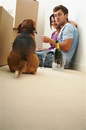 real estate couple not broker not consultant not lawyer not illustration - Couple Eating Pizza in New Home with Dog Stock Photo - Premium Royalty-Free, Code: 600-01838287