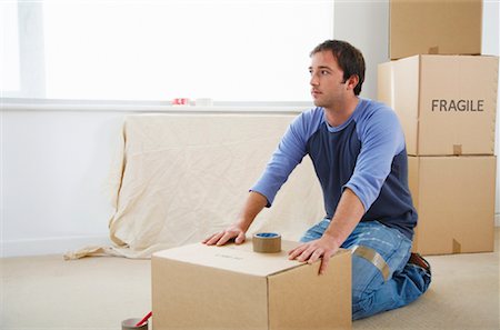 person taping a box - Man Packing Boxes Stock Photo - Premium Royalty-Free, Code: 600-01838317