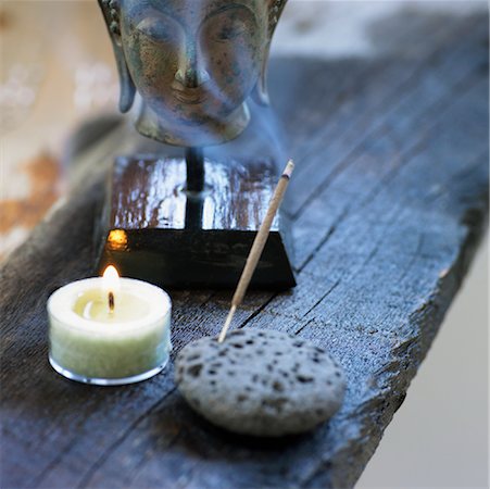 Still Life of Head of Buddha, Candle, and Incense Stock Photo - Premium Royalty-Free, Code: 600-01838653