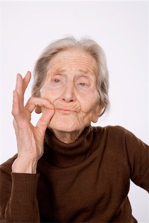 Woman Making Smoking Gesture Stock Photo - Premium Royalty-Free, Code: 600-01879178