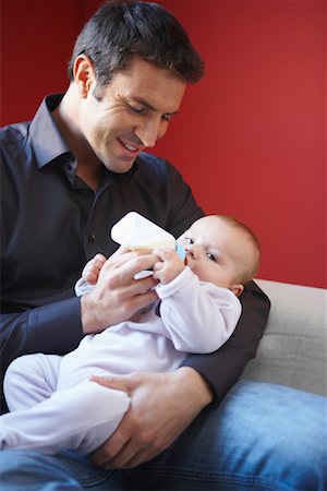 father holding son in lap - Father Feeding Baby with Bottle Stock Photo - Premium Royalty-Free, Code: 600-01887407