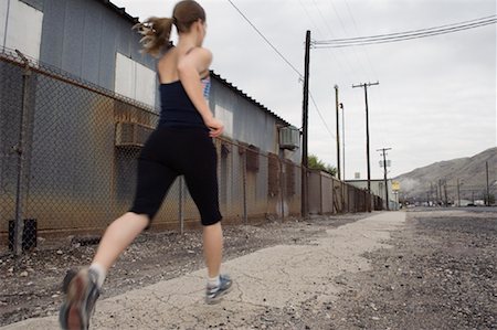 Woman Running on Sidewalk Stock Photo - Premium Royalty-Free, Code: 600-01954171