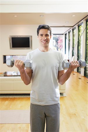 Man Exercising in Living Room Stock Photo - Premium Royalty-Free, Code: 600-01954796