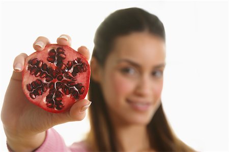 simsearch:600-01630171,k - Woman Holding Pomegranate Foto de stock - Royalty Free Premium, Número: 600-01954846