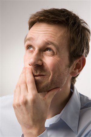 puzzled person white background - Portrait of Man Thinking Stock Photo - Premium Royalty-Free, Code: 600-02010057