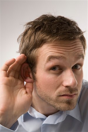 raised eyebrow businessman - Portrait of Man Cupping Ear Stock Photo - Premium Royalty-Free, Code: 600-02010062