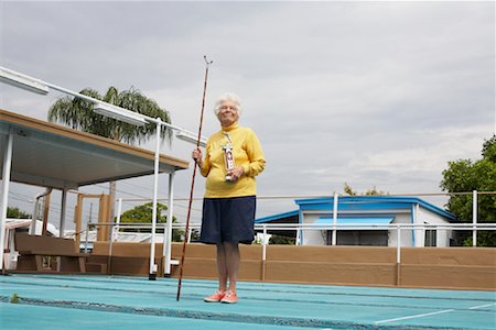 senior woman portrait looking at camera alone full body stand - Portrait of Shuffleboard Champion, Florida, USA Stock Photo - Premium Royalty-Free, Code: 600-02046082