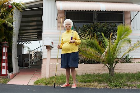 senior woman portrait looking at camera alone full body stand - Portrait of Shuffleboard Champion, Florida, USA Stock Photo - Premium Royalty-Free, Code: 600-02046083