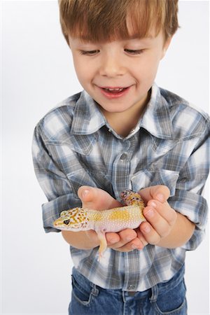 reptile on white - Boy Holding Lizard Stock Photo - Premium Royalty-Free, Code: 600-02055745