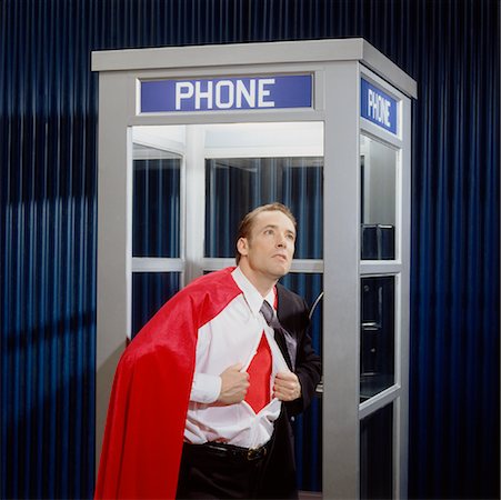 Man Opening Shirt to Reveal Super Hero Costume in Phone Booth Foto de stock - Sin royalties Premium, Código: 600-02071275