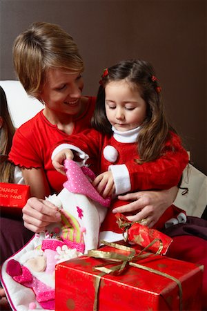 simsearch:600-02756537,k - Mother and Daughter Opening Christmas Stocking Stock Photo - Premium Royalty-Free, Code: 600-02071827