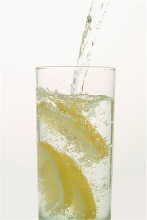 eau pétillante - Eau couler dans le verre avec des citrons Photographie de stock - Premium Libres de Droits, Code: 600-02080683