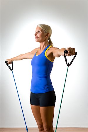 simsearch:600-01163693,k - Woman Using Exercise Band Stock Photo - Premium Royalty-Free, Code: 600-02080829