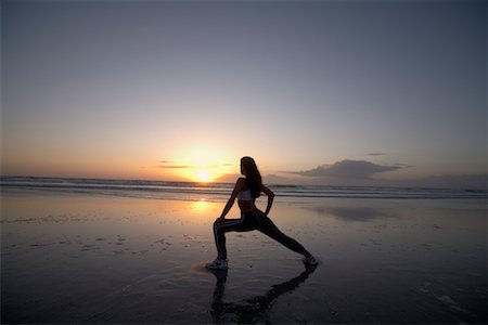 sunset in florida - Woman Stretching on Beach at Sunset, Jacksonville Beach, Florida, USA Foto de stock - Sin royalties Premium, Código: 600-02081507