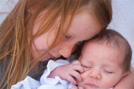 sister hugs baby - Portrait of Girl with Baby Sister Stock Photo - Premium Royalty-Free, Code: 600-02081563