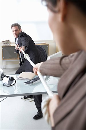 dominant man - Business People in Tug-of-War at Desk Stock Photo - Premium Royalty-Free, Code: 600-02081762