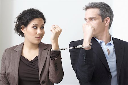 simsearch:846-05648121,k - Businessman and Businesswoman Handcuffed Together Stock Photo - Premium Royalty-Free, Code: 600-02081774