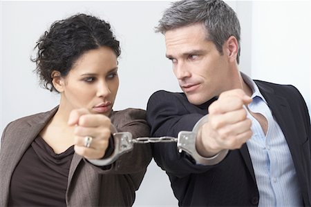 simsearch:600-02798122,k - Businessman and Businesswoman Handcuffed Together Stock Photo - Premium Royalty-Free, Code: 600-02081775