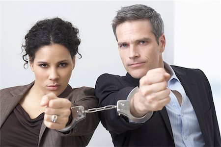 Businessman and Businesswoman Handcuffed Together Stock Photo - Premium Royalty-Free, Code: 600-02081776
