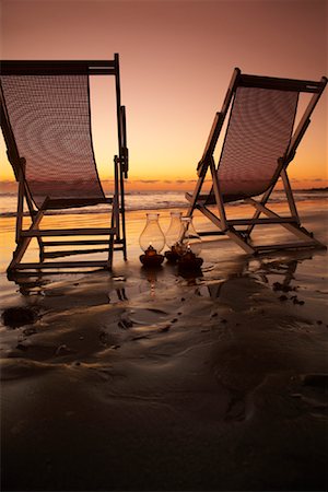 dusk empty - Beach Chairs with Oil Lamps on Beach Stock Photo - Premium Royalty-Free, Code: 600-02121181