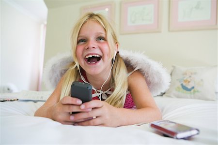 singing with head phone - Young Girl Listening to Music Stock Photo - Premium Royalty-Free, Code: 600-02121626